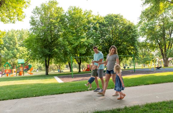 People walk near play equipment