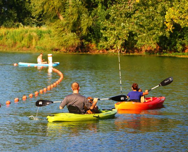 People in two kayaks on body of water